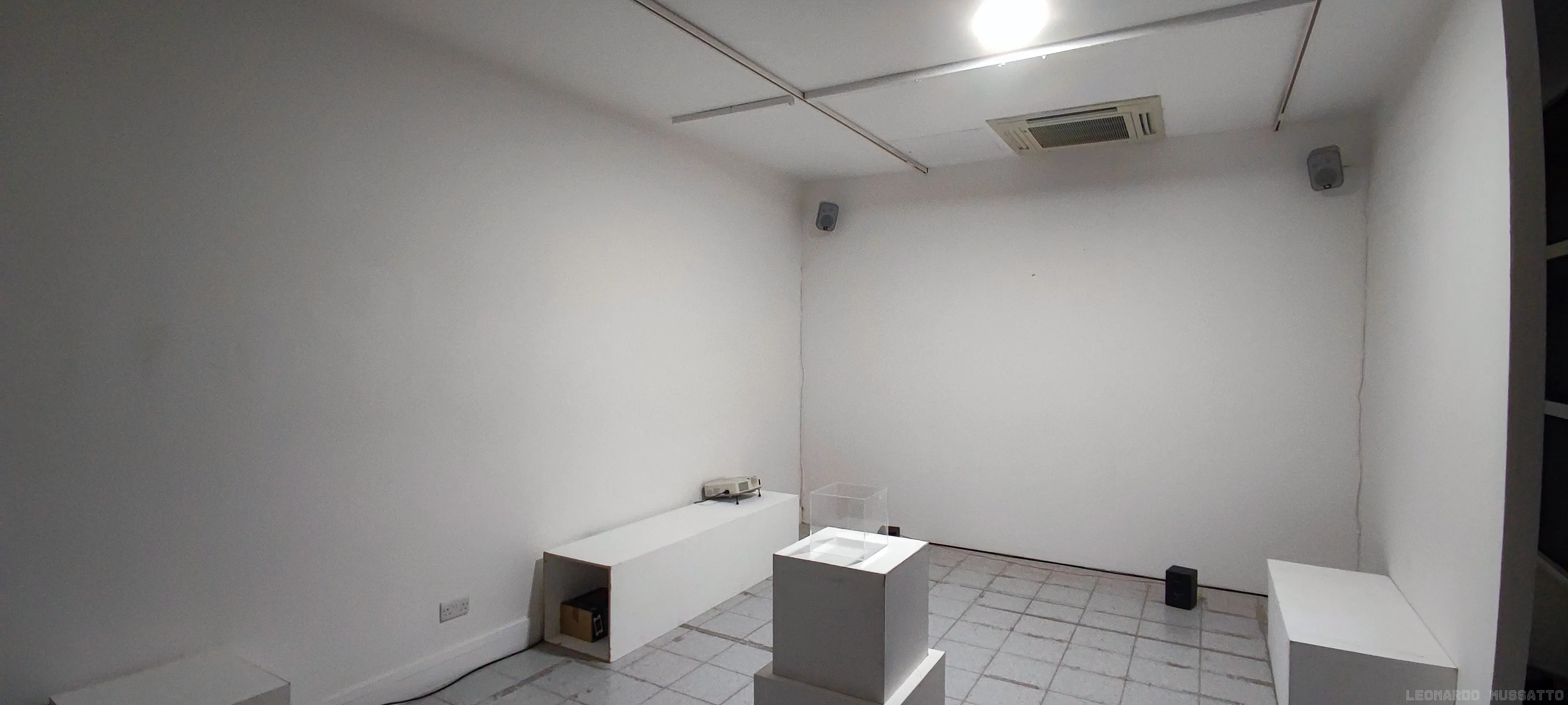 Initial room setup: two cubes stacked at the center of the room, projectors sitting on the benches along the walls, speakers on the ground